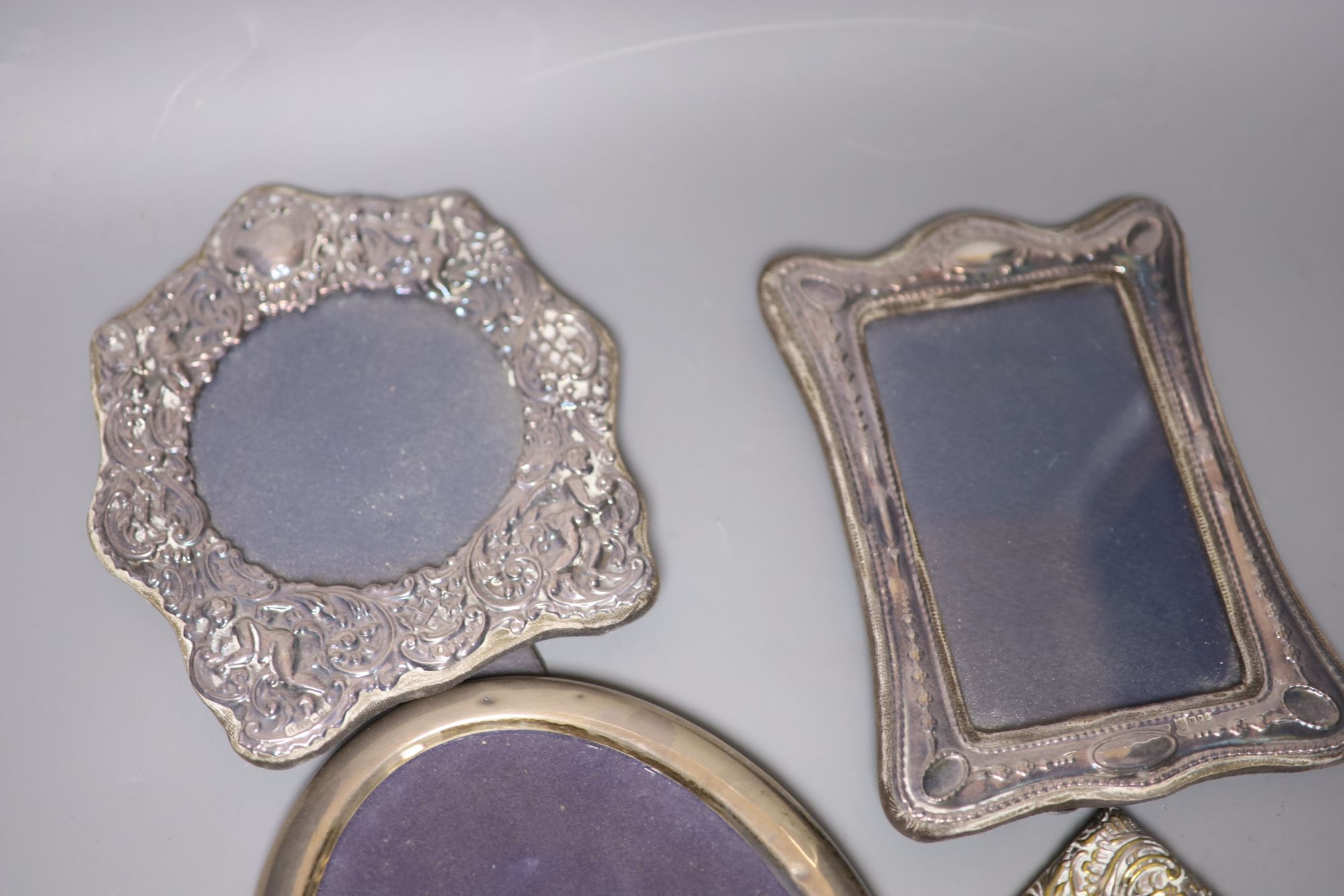 Four assorted silver mounted photograph frames, largest 21cm, one other white metal frame and a brass frame.